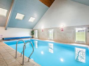 a large swimming pool with blue water at Cuckoo in Bakewell