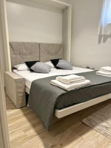 a bedroom with a bed with two towels on it at NEWHOUSE ROOFTOP in Nettuno