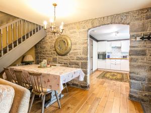 a kitchen and dining room with a table and chairs at Bramble in Bakewell