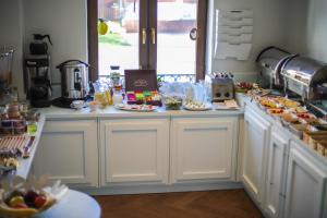 a kitchen with many plates of food on a counter at Willa Puck in Puck