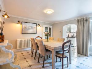 a dining room with a wooden table and chairs at The Belle in Bakewell