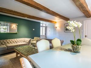 a living room with a table and chairs at The Aubrey in Bakewell