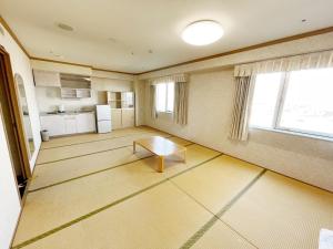 a large room with a table and a kitchen at Hotel KOYO Bekkan - Vacation STAY 37061v in Hashima