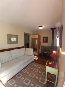 a living room with a white couch and a table at Bigfoot RV & Cabins Park in Happy Camp