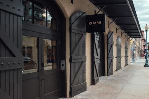 a building with a sign on the side of it at Roami at The Luzianne in New Orleans
