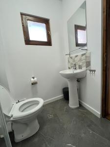 a bathroom with a toilet and a sink at Pensiunea Mac in Vama Veche