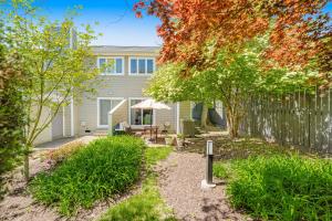 a home with a fence and a backyard at Scarborough Village - 245 Country Club Dr, Unit #608 in Rehoboth Beach
