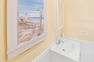 a bathroom with a bath tub and a painting on the wall at Scarborough Village - 245 Country Club Dr, Unit #608 in Rehoboth Beach +16 photos