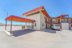 a gas station with a car parked in a parking lot at Mojave Hotel in Mojave