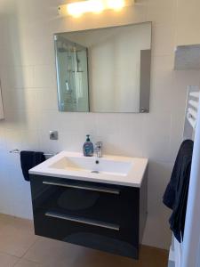a bathroom with a white sink and a mirror at Belmont 2/2 in L'Estartit +18 photos
