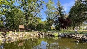 a pond in a park with a statue next to it at VILLA SELVA - Piemonte in Agrate Conturbia