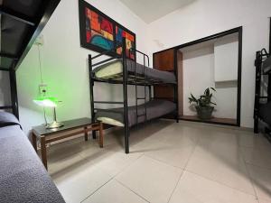 a room with two bunk beds and a table with a lamp at Link Cordoba Hostel in Cordoba