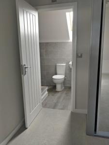 an open door to a bathroom with a toilet at Chandra House in Swindon