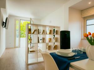 uma sala de jantar com uma mesa e uma prateleira com livros em Villa Ada Olbia em Olbia