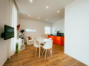 a kitchen and living room with a table and chairs at Villa Ada Olbia in Olbia