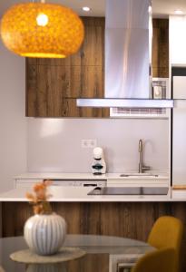 a kitchen with a sink and a counter top at Apartamentos Fleming in Albacete