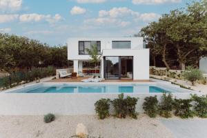 a house with a swimming pool in front of it at D-Tree HOUSE private heated pool in Potocnica