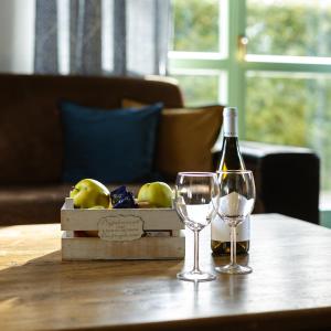 una bottiglia di vino e due bicchieri su un tavolo di Michałowy Domek koło Karpacza - Apartamentuj a Karpacz