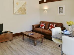 a living room with a couch and a coffee table at Little Hoot in Baslow
