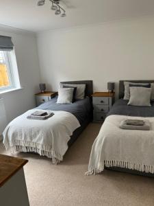 a bedroom with two beds and a window at Bescot House Bramble Hill Bude 4 bed det house in Bude