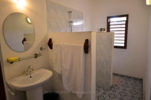 a bathroom with a sink and a mirror at L'antafa in Ambondrona +26 photos