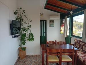 a dining room with a table and chairs at Strofi House in Argoulés
