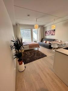 a living room with a bed and a table at studio Finnoo Espoo next to metro, easy to reach Helsinki and Otaniemi, Aalto in Espoo
