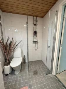 a bathroom with a toilet and a glass shower at studio Finnoo Espoo next to metro, easy to reach Helsinki and Otaniemi, Aalto in Espoo