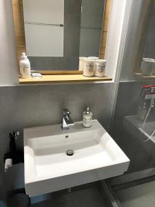 a bathroom with a white sink and a mirror at Residenz Davos von Swisspartments in Davos