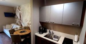 a small kitchen with a table and a sink at Apartament Aqua 27 Premium nearby Beach in Świnoujście