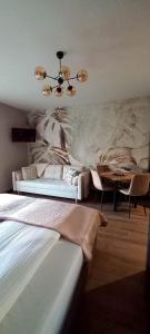 a bedroom with a bed and a chandelier at Apartament Aqua 27 Premium nearby Beach in Świnoujście