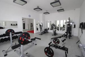 a gym with many exercise equipment in a room at Apartament SŁONECZKO Rezydencja Ustronie Morskie in Ustronie Morskie