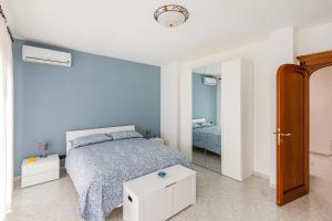 a blue bedroom with a bed and a mirror at La Casa di Adalgisa in Fasano
