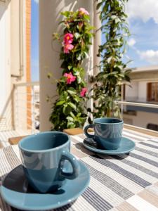two blue cups and saucers sitting on a table at La Casa di Adalgisa in Fasano