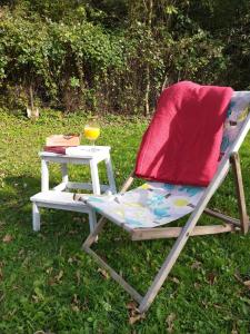 a chair with a side table in the grass at Przywiśle in Ustroń