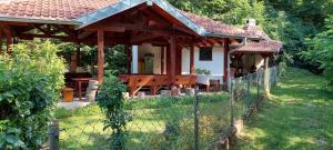 a small house with a fence in front of it at Vitez Koja in Vrnjačka Banja