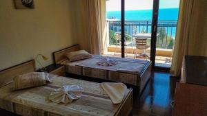 two beds in a room with a view of the ocean at Europroperties Bendita Mare Apartments in Golden Sands +227 photos