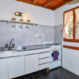 a kitchen with a sink and a stove at Melipal Schuss ARG41 in San Carlos de Bariloche