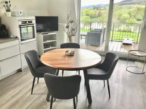 a kitchen with a table and chairs and a kitchen with a balcony at Mosel Palais in Ürzig