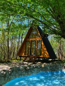 a tree house in the woods with a pool at Cottage Villa Ioseliani in Kumistavi