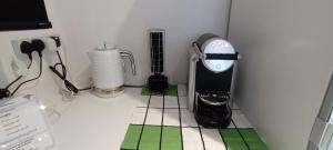 a kitchen counter with a blender and other appliances at Phoenix Heights in London