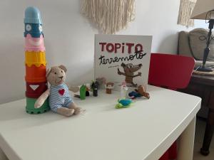 a white table with stuffed animals and a sign on it at Lost Paradise in San Andrés