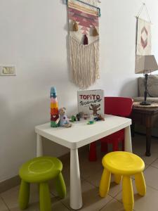 a toy table with two stools and a table with a toy at Lost Paradise in San Andrés