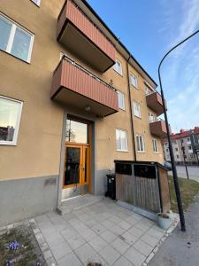 a apartment building with a door and a porch at Etage flat Stockholm Stora Essingen in Stockholm