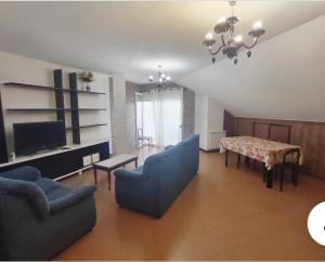 a living room with a table and chairs and a dining room at Piso en Ajo con piscina comunitaria in Ajo