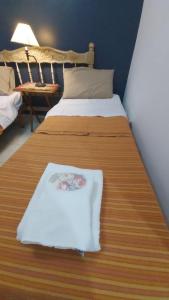 a bed with a white towel on top of it at Guest House Santiago in Santiago del Estero