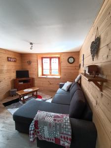 salon z niebieską kanapą i stołem w obiekcie Chez ma Grand-mère w mieście Saint-Félix