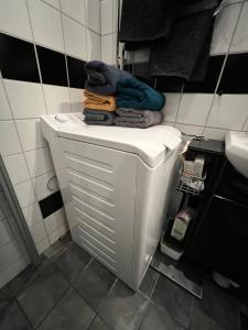 a white toilet in a bathroom with towels on it at Etage flat Stockholm Stora Essingen in Stockholm +49 photos