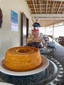 a bundt cake sitting on a plate on a counter at Pousada Corais de Maracajaú in Maracajaú