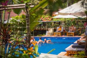 a group of people in a swimming pool at La Mer Resort, Phú Quốc in Phú Quốc